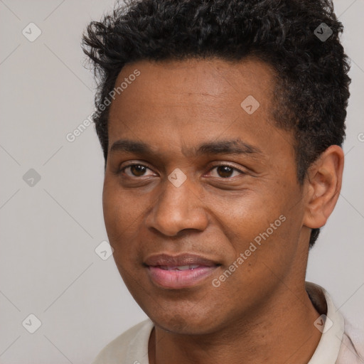 Joyful black adult male with short  black hair and brown eyes