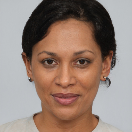 Joyful latino adult female with short  brown hair and brown eyes