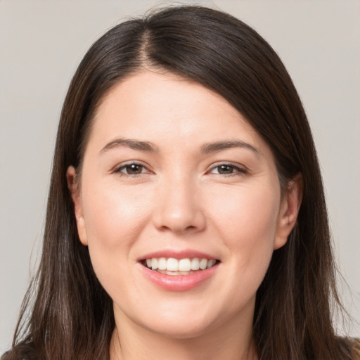 Joyful white young-adult female with long  brown hair and brown eyes