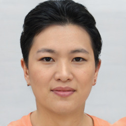 Joyful asian young-adult female with short  brown hair and brown eyes