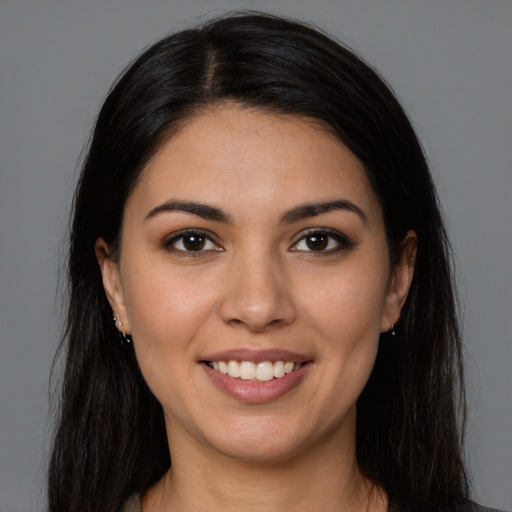 Joyful latino young-adult female with long  brown hair and brown eyes