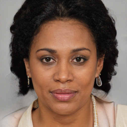 Joyful latino adult female with medium  brown hair and brown eyes