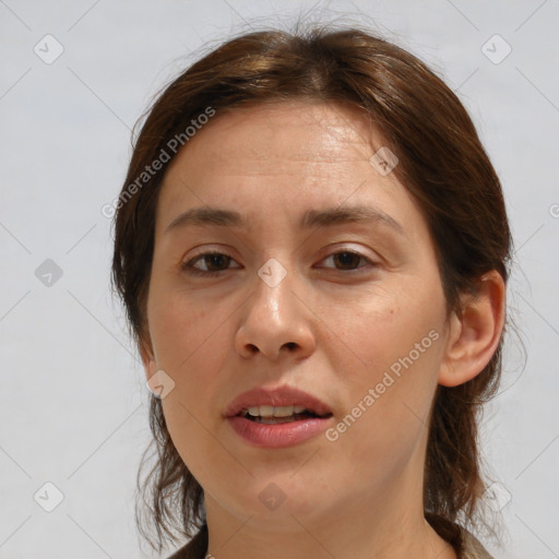 Joyful white adult female with medium  brown hair and brown eyes