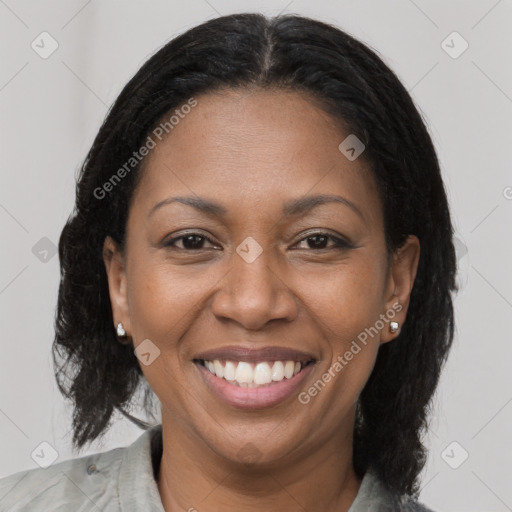 Joyful black adult female with medium  brown hair and brown eyes