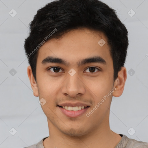 Joyful latino young-adult male with short  brown hair and brown eyes