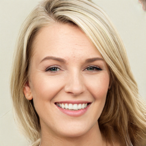 Joyful white young-adult female with long  brown hair and green eyes