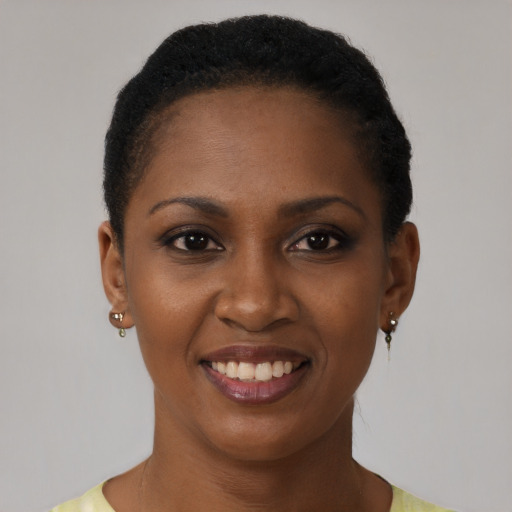 Joyful black young-adult female with short  brown hair and brown eyes