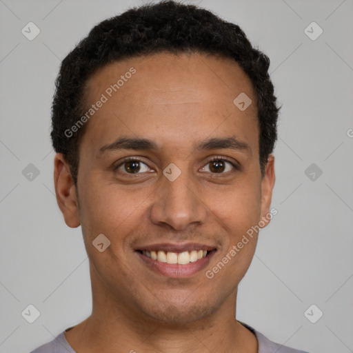 Joyful latino young-adult male with short  brown hair and brown eyes