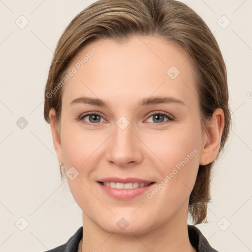 Joyful white young-adult female with medium  brown hair and grey eyes