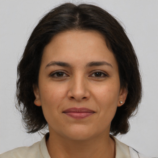 Joyful latino young-adult female with medium  brown hair and brown eyes