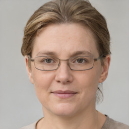 Joyful white adult female with short  brown hair and grey eyes