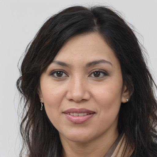 Joyful asian young-adult female with long  brown hair and brown eyes