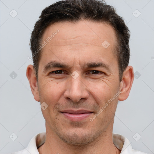 Joyful white adult male with short  brown hair and brown eyes