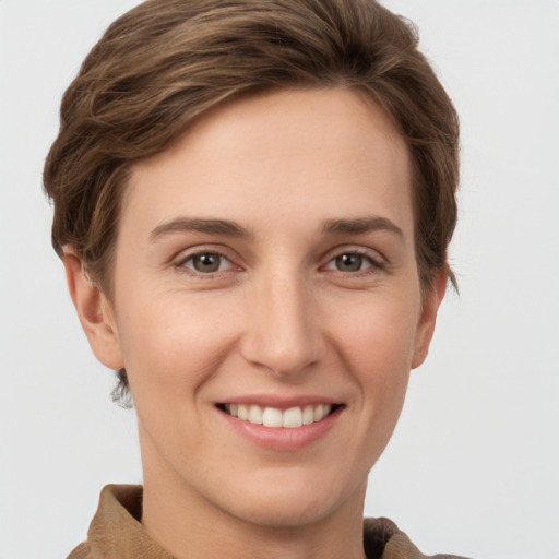 Joyful white young-adult female with short  brown hair and grey eyes