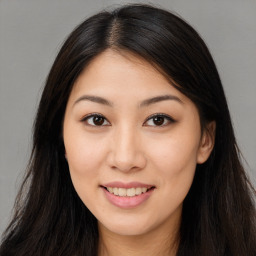 Joyful asian young-adult female with long  brown hair and brown eyes