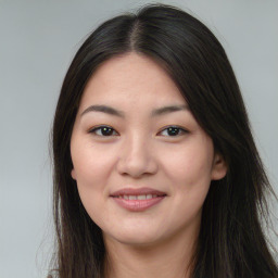 Joyful asian young-adult female with long  brown hair and brown eyes