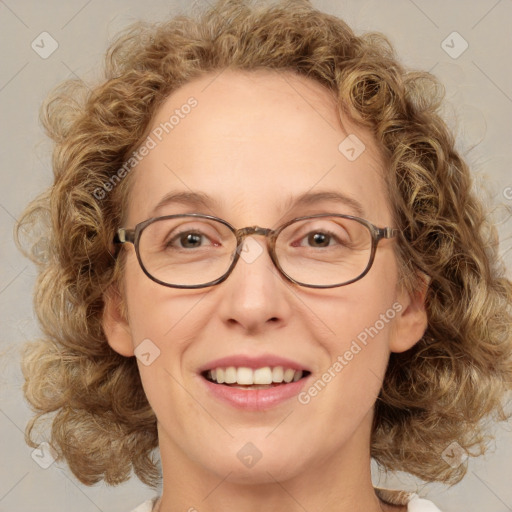 Joyful white adult female with medium  brown hair and blue eyes