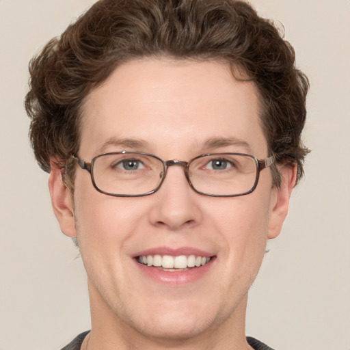 Joyful white adult male with short  brown hair and grey eyes