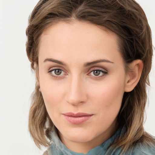 Joyful white young-adult female with medium  brown hair and blue eyes