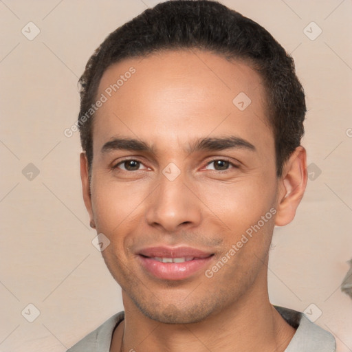 Joyful white young-adult male with short  black hair and brown eyes