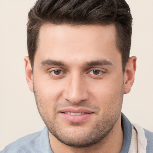 Joyful white young-adult male with short  brown hair and brown eyes