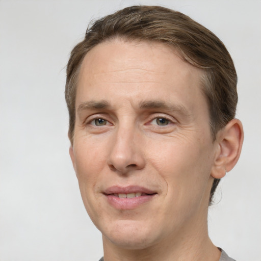 Joyful white adult male with short  brown hair and grey eyes