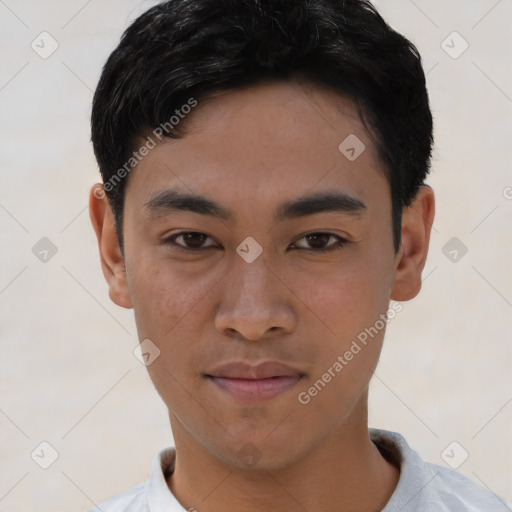 Joyful asian young-adult male with short  brown hair and brown eyes