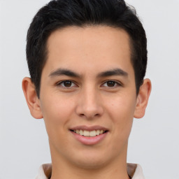 Joyful latino young-adult male with short  brown hair and brown eyes