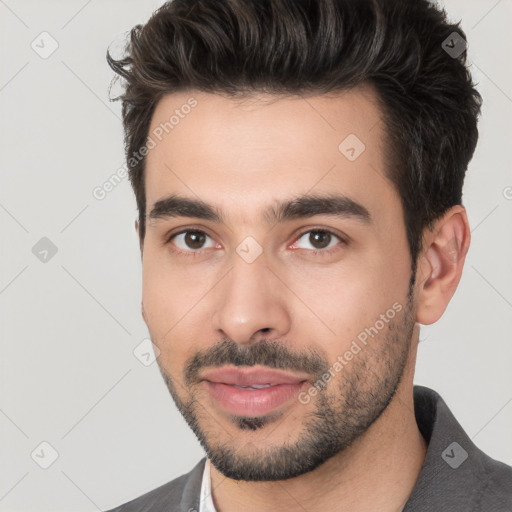 Joyful white young-adult male with short  black hair and brown eyes