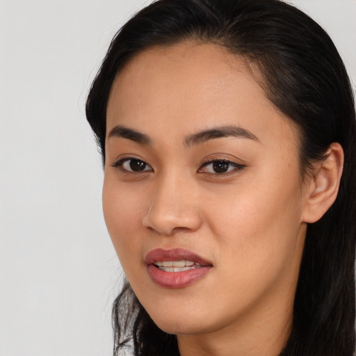 Joyful asian young-adult female with long  brown hair and brown eyes