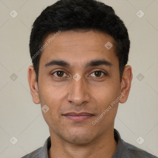 Joyful latino adult male with short  black hair and brown eyes