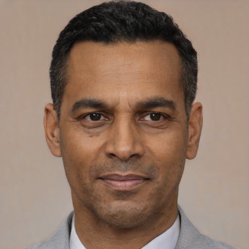 Neutral latino adult male with short  black hair and brown eyes