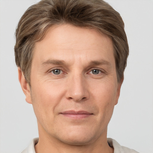 Joyful white adult male with short  brown hair and grey eyes