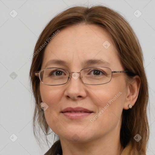 Joyful white adult female with medium  brown hair and blue eyes