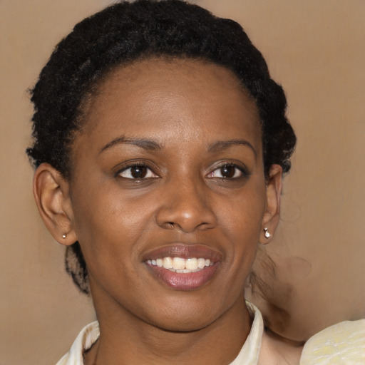 Joyful black young-adult female with short  brown hair and brown eyes