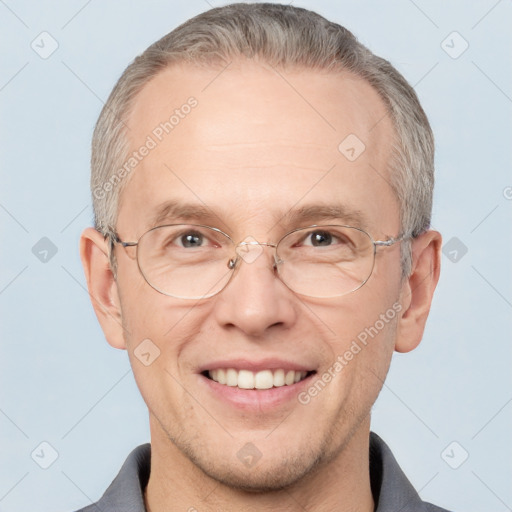 Joyful white adult male with short  brown hair and brown eyes