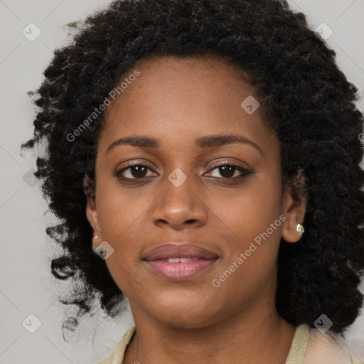 Joyful black young-adult female with long  brown hair and brown eyes