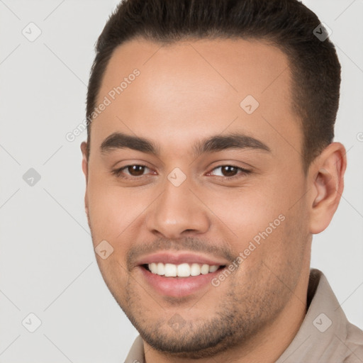 Joyful white young-adult male with short  brown hair and brown eyes