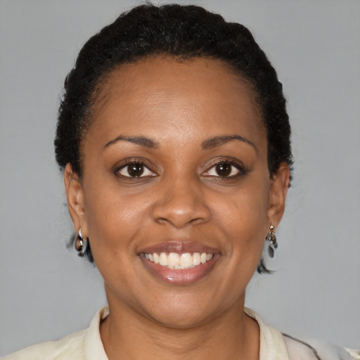 Joyful black adult female with short  brown hair and brown eyes