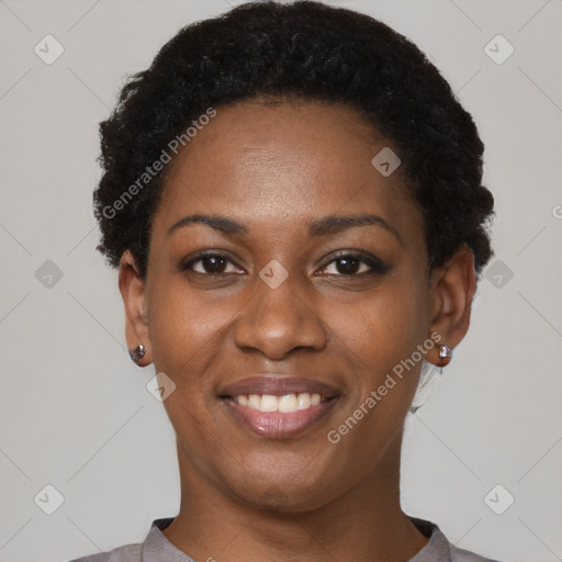 Joyful black young-adult female with short  black hair and brown eyes