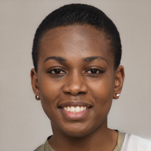 Joyful black young-adult female with short  black hair and brown eyes