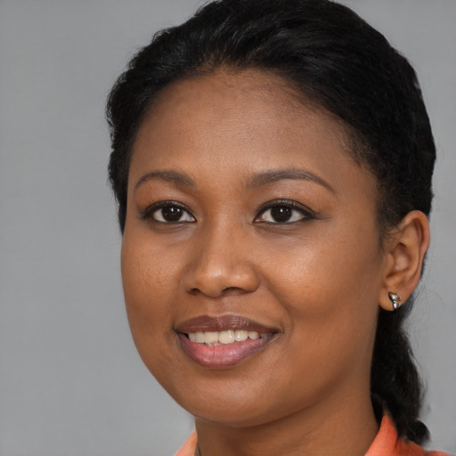 Joyful black young-adult female with medium  brown hair and brown eyes