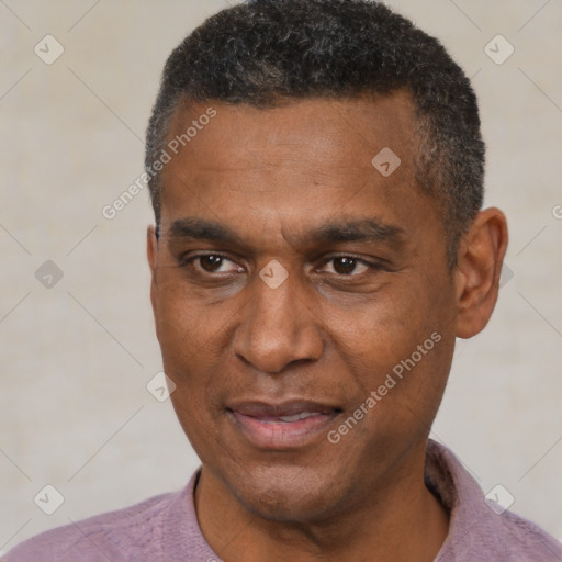 Joyful black adult male with short  black hair and brown eyes