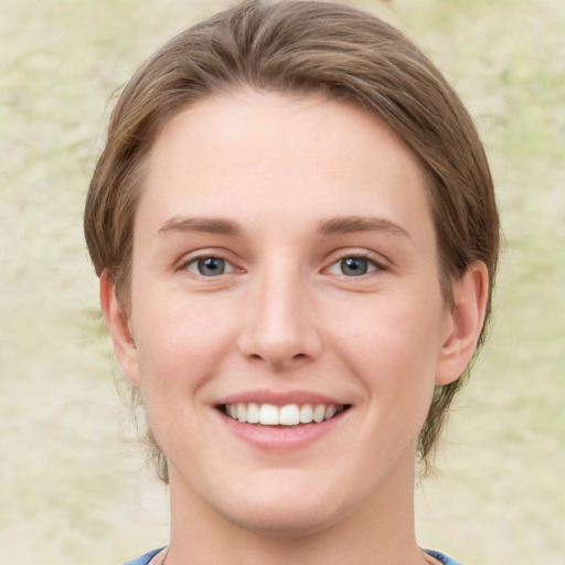 Joyful white young-adult female with medium  brown hair and green eyes