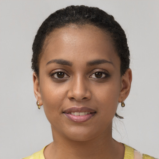 Joyful black young-adult female with short  brown hair and brown eyes