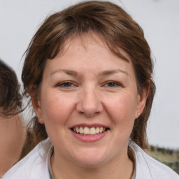 Joyful white adult female with medium  brown hair and brown eyes