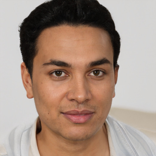 Joyful white young-adult male with short  black hair and brown eyes