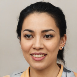 Joyful latino young-adult female with medium  brown hair and brown eyes