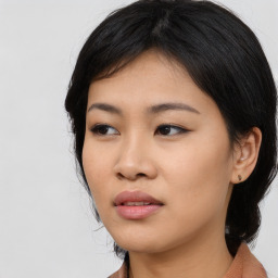 Joyful asian young-adult female with medium  black hair and brown eyes