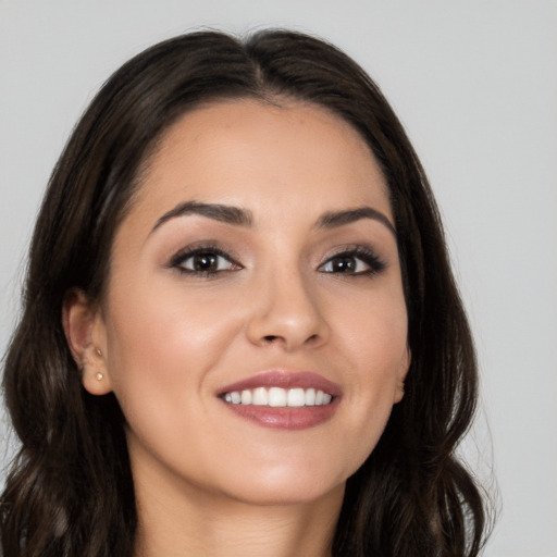 Joyful white young-adult female with long  brown hair and brown eyes